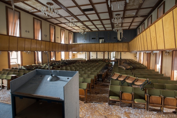 Adam X Urbex Nazi School Partishule N DDR Horsaal Germany Urban Exploration Decay Lost Abandoned auditorium ceiling seats chairs view from the stage lectern